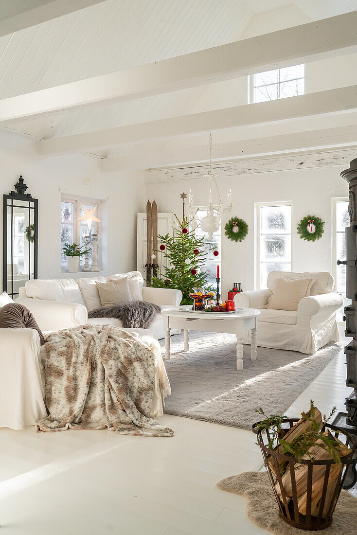 Living room with Christmas decorations, white interior and fireplace