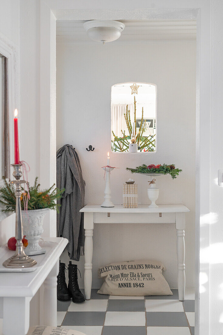 Hallway with white console table and Christmas decorations