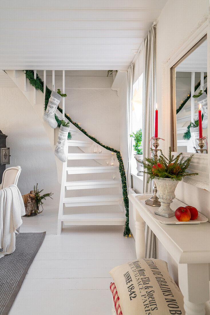 Staircase decorated for Christmas with garland