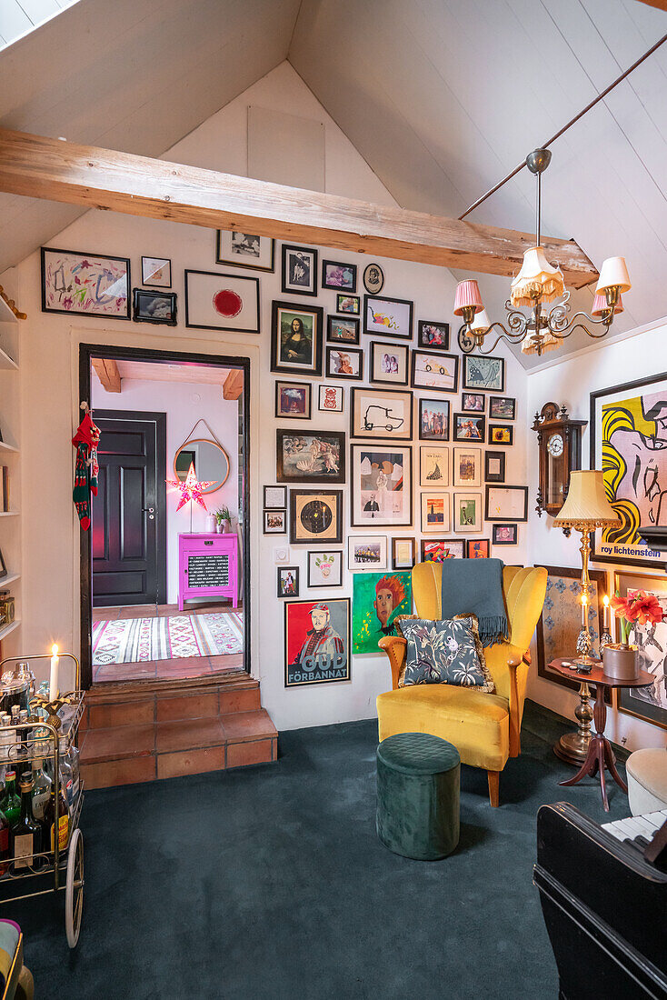 Living room with gallery wall, yellow armchair and varied decoration