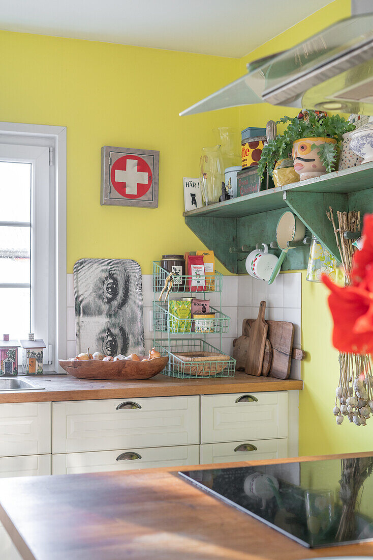 Colourful country kitchen with retro accessories and yellow walls