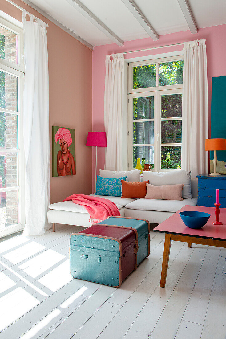 Bright living room with colorful accents and seating under window