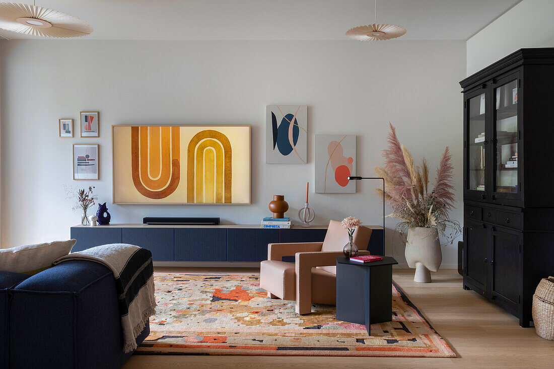 Modern living room with colourful carpet and graphic artwork