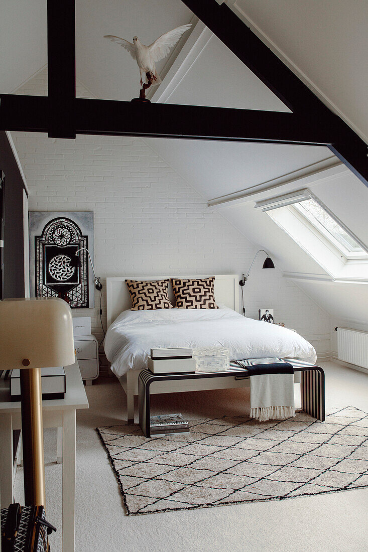 Attic bedroom with exposed beams and modern design