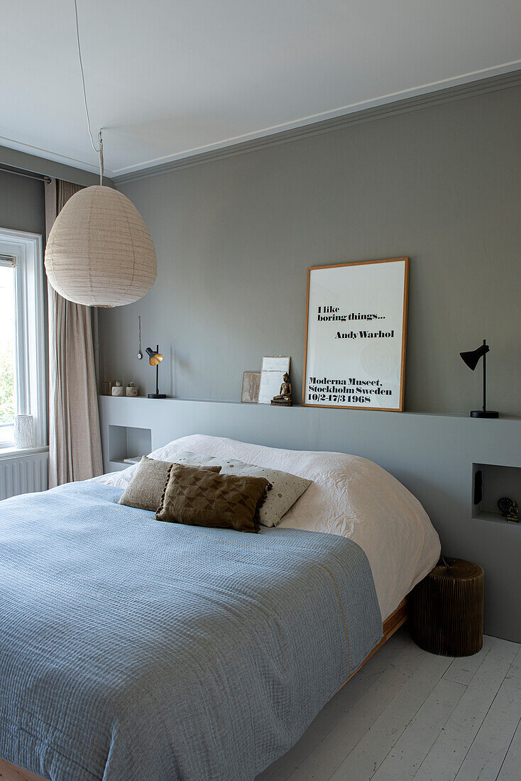 Modern bedroom with grey walls and hanging lamp