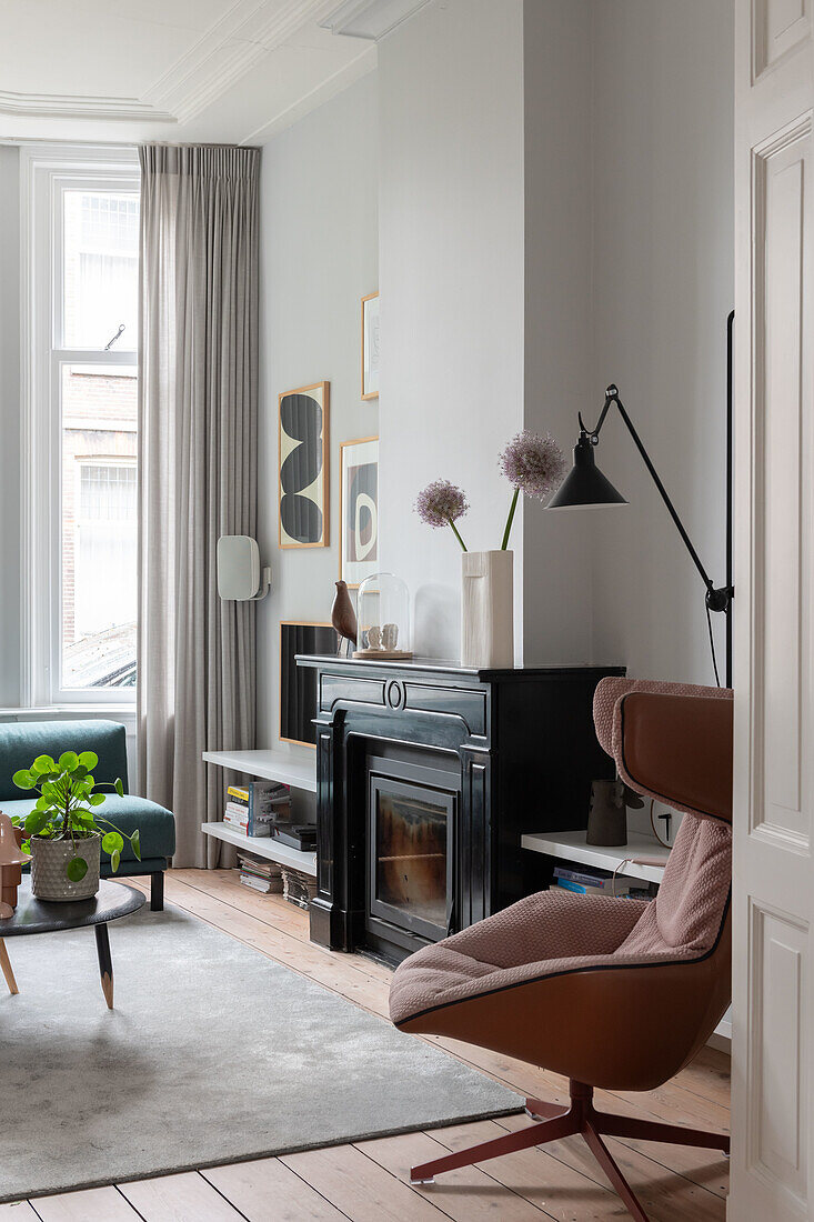 Living room with wood-burning stove and modern armchair