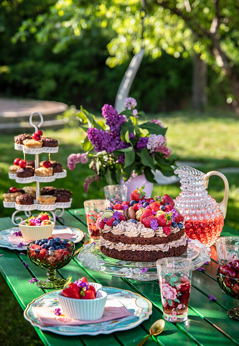 Table setting with cake, fruit bowls and bouquet of flowers