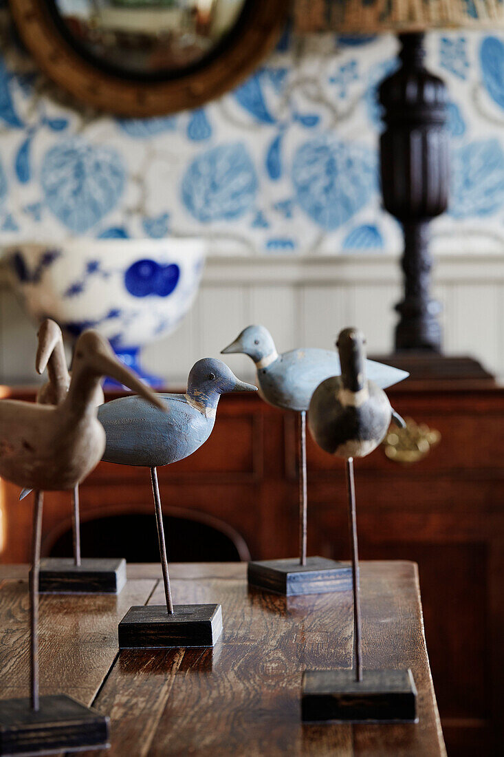 Bird ornaments on wooden tabletop in North Yorkshire farmhouse, UK