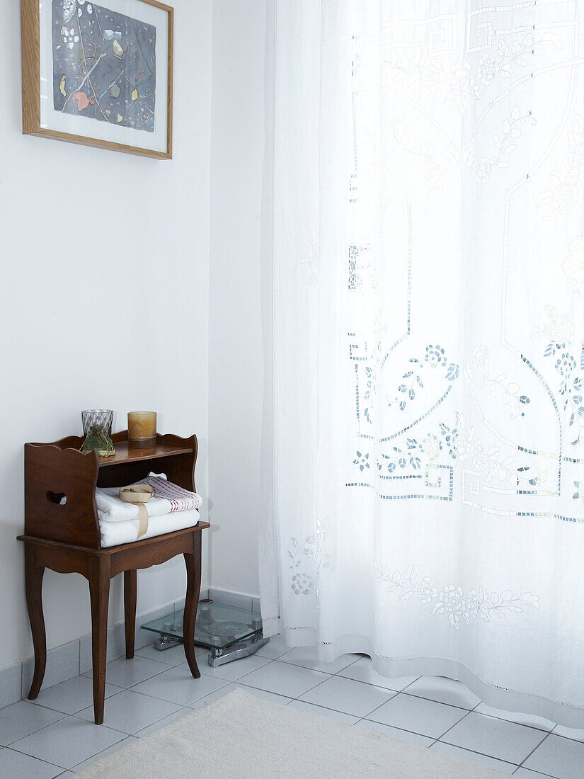 Bathroom with large window and voile curtain