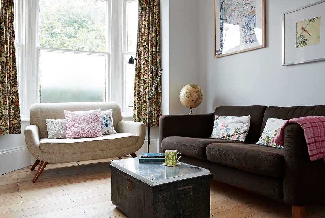 Retro style sofas in bay window of Colchester family home, Essex, England, UK