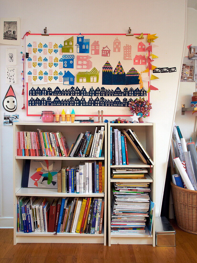 Bookcase storage and artwork in child's room of French family home