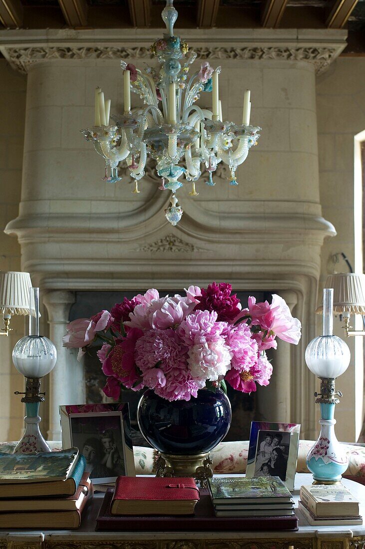 Still life with pink peonies with fireplace in background