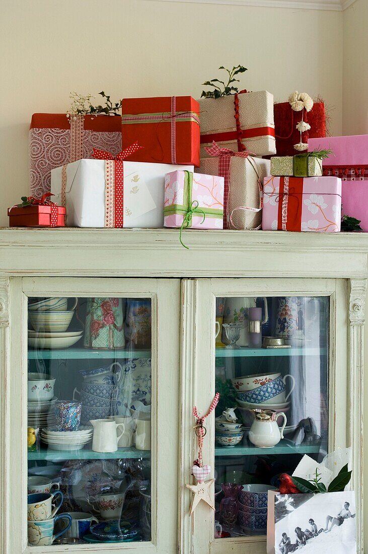Cupboard full of Crockery with Christmas presents on it