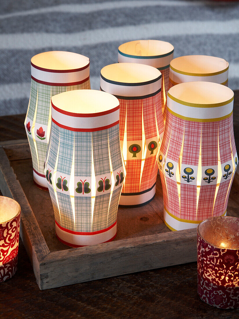 Lit lanterns and tealight holders in Herefordshire cottage, England, UK