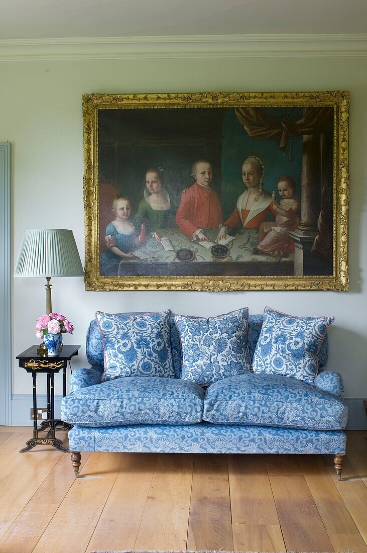 Living room in the cottage with painting in golden frame