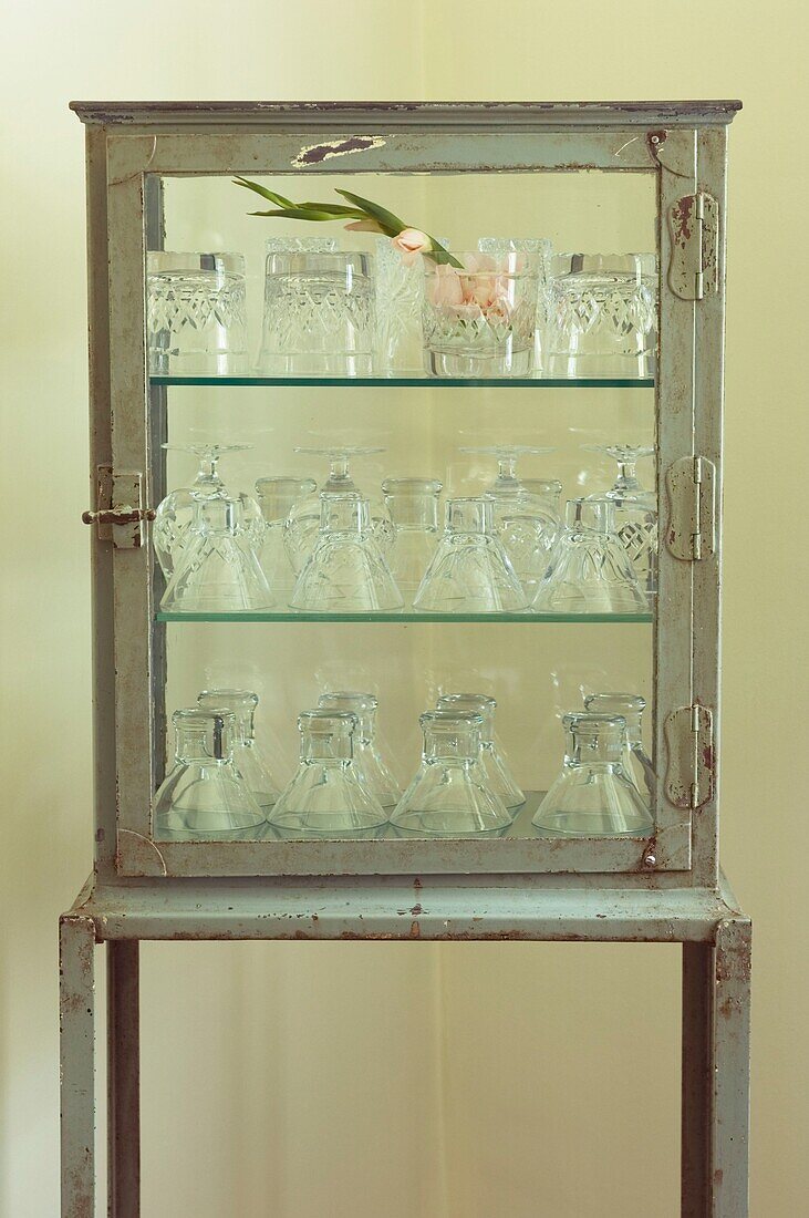Cabinet with glasses and flower