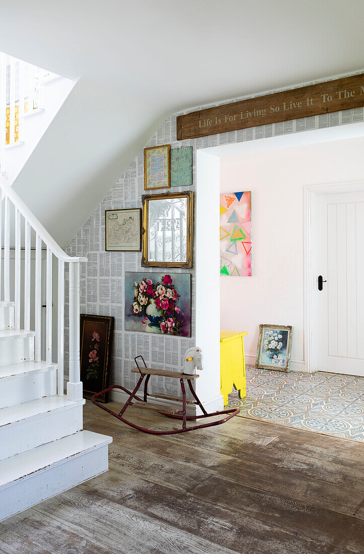 Rocking horse and framed artwork in hallway of Guildford home, Surrey, UK