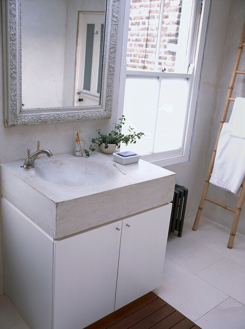 Custom built bathroom sink in cast concrete in modern white bathroom