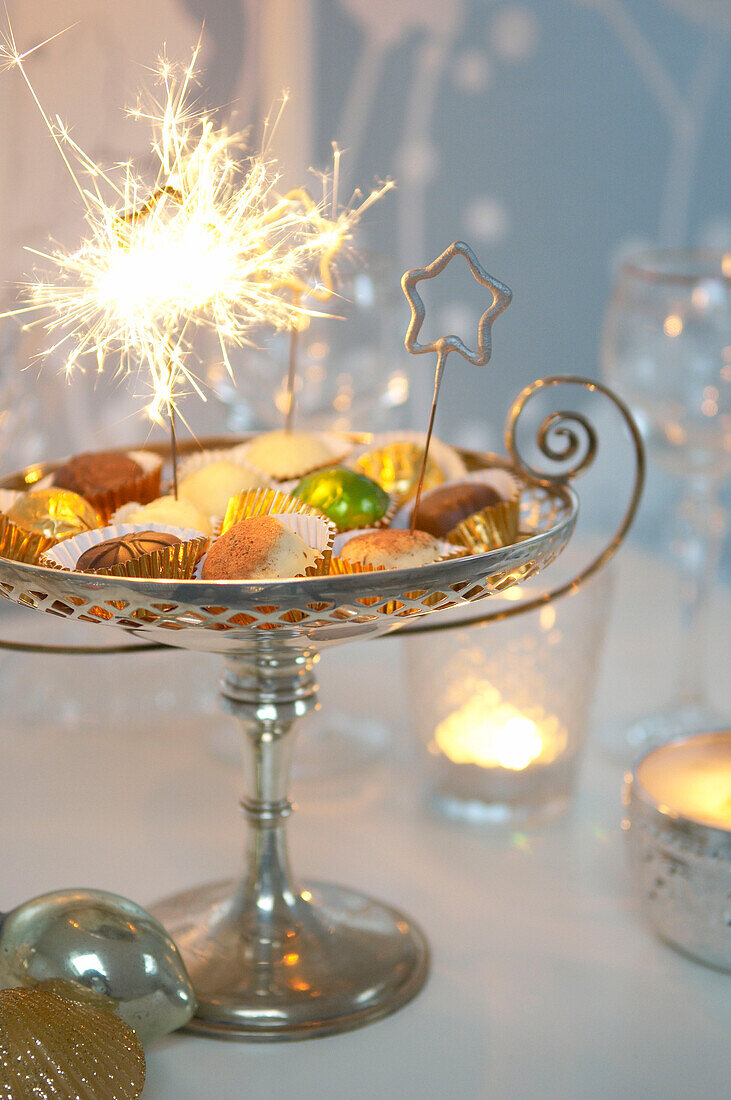 Party scene tabletop with chocolates and sparklers