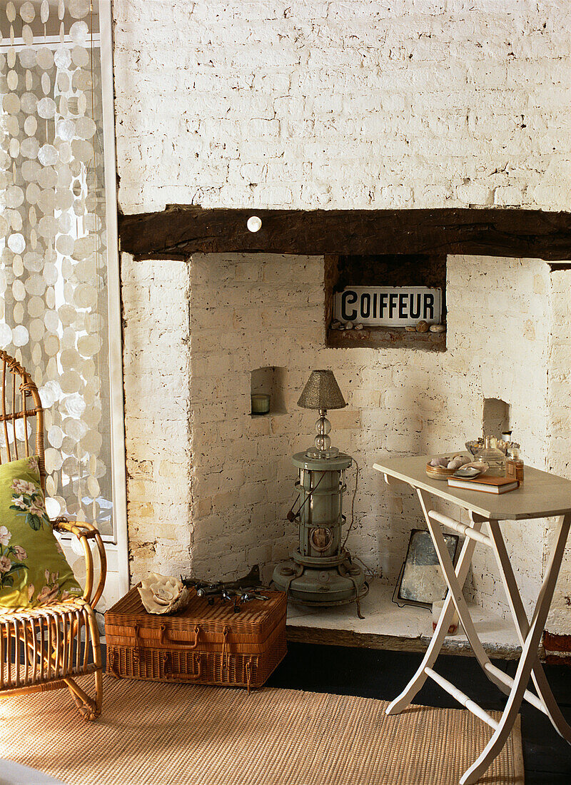 Fireplace with painted brickwork and collection of vintage nautical objects