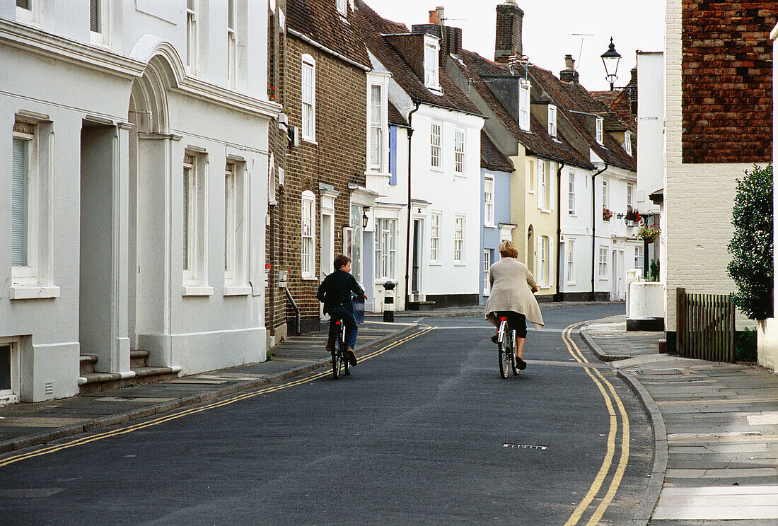 Mother and son cycling up the high street in Deal 