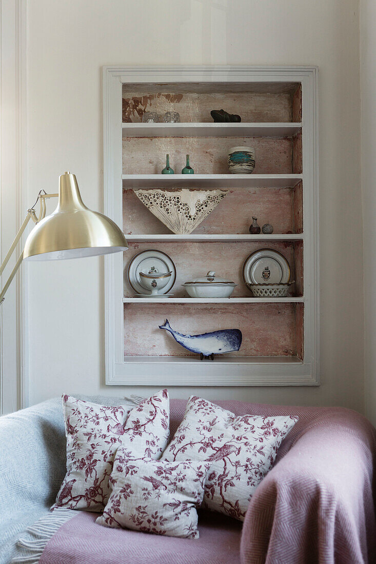 Ornaments on recessed shelves above sofa in Somerset home UK