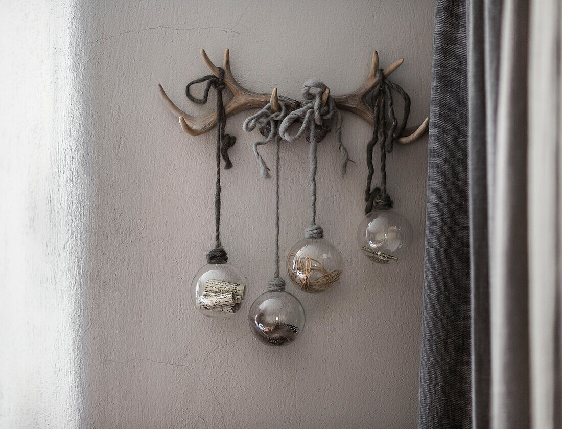 Four glass baubles hanging on antlers in Somerset home UK