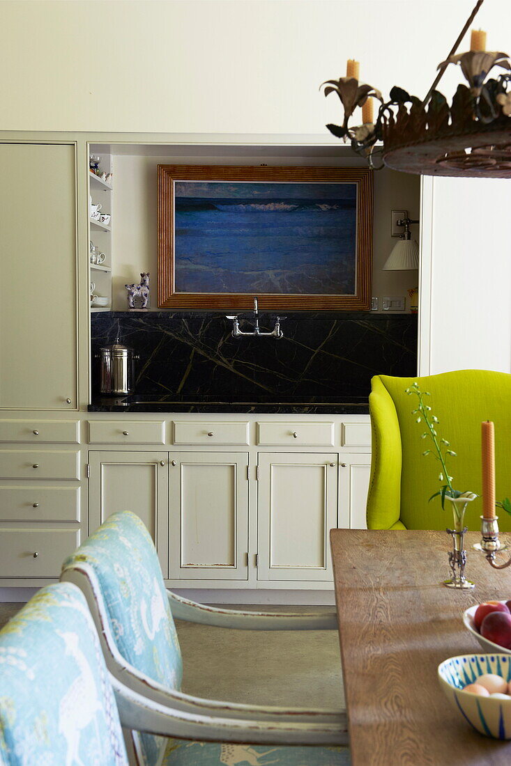Sink detail with gilt framed artwork in dining room of Massachusetts home, New England, USA
