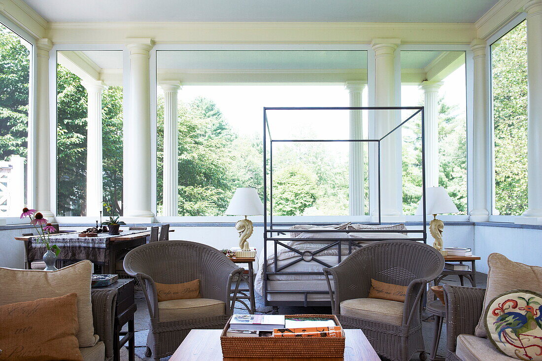 Open plan studio with metal framed bed and pillars in Massachusetts home, New England, USA