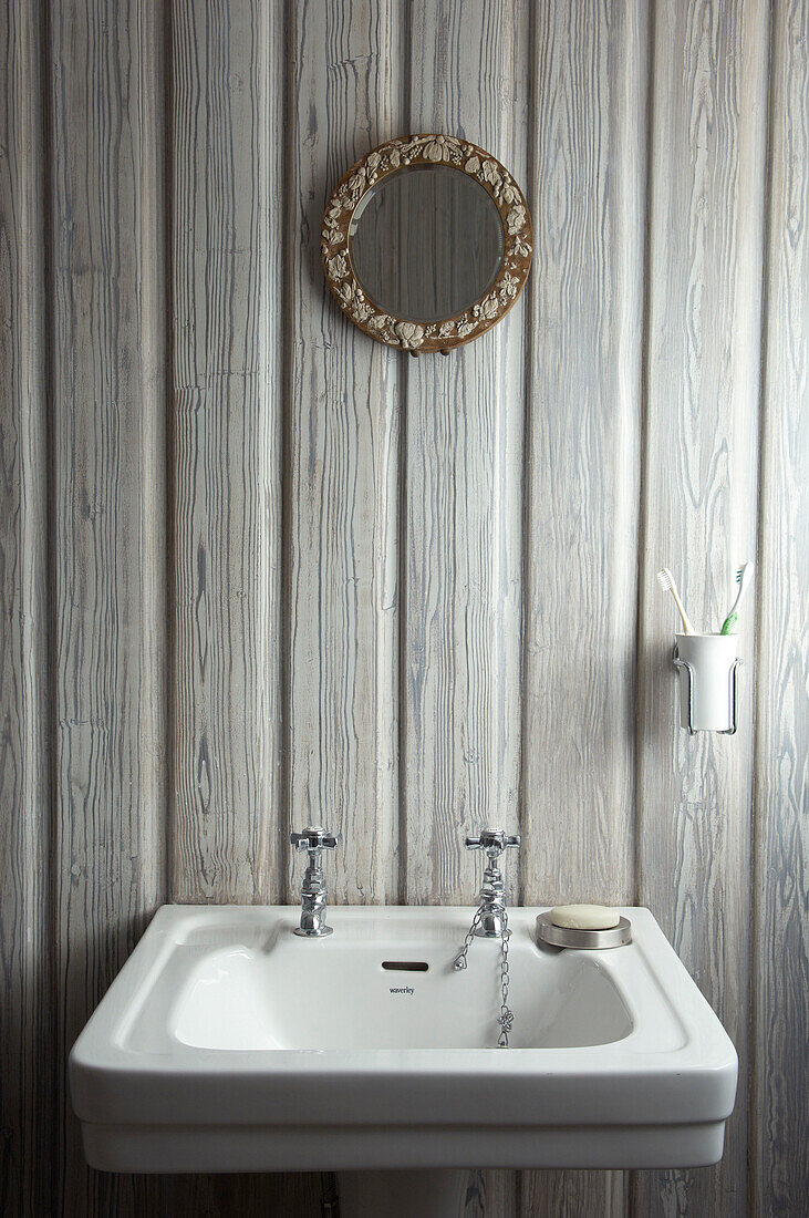 Pedestal base sink and mirror in Hastings beach house England UK