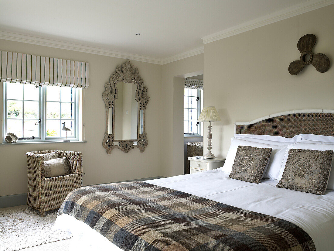 Neutral bedroom with propeller above bed