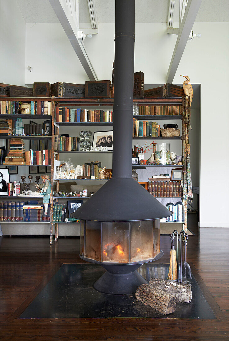 Freestanding fireplace and bookcase in open plan Sheffield home, Berkshire County, Massachusetts, United States
