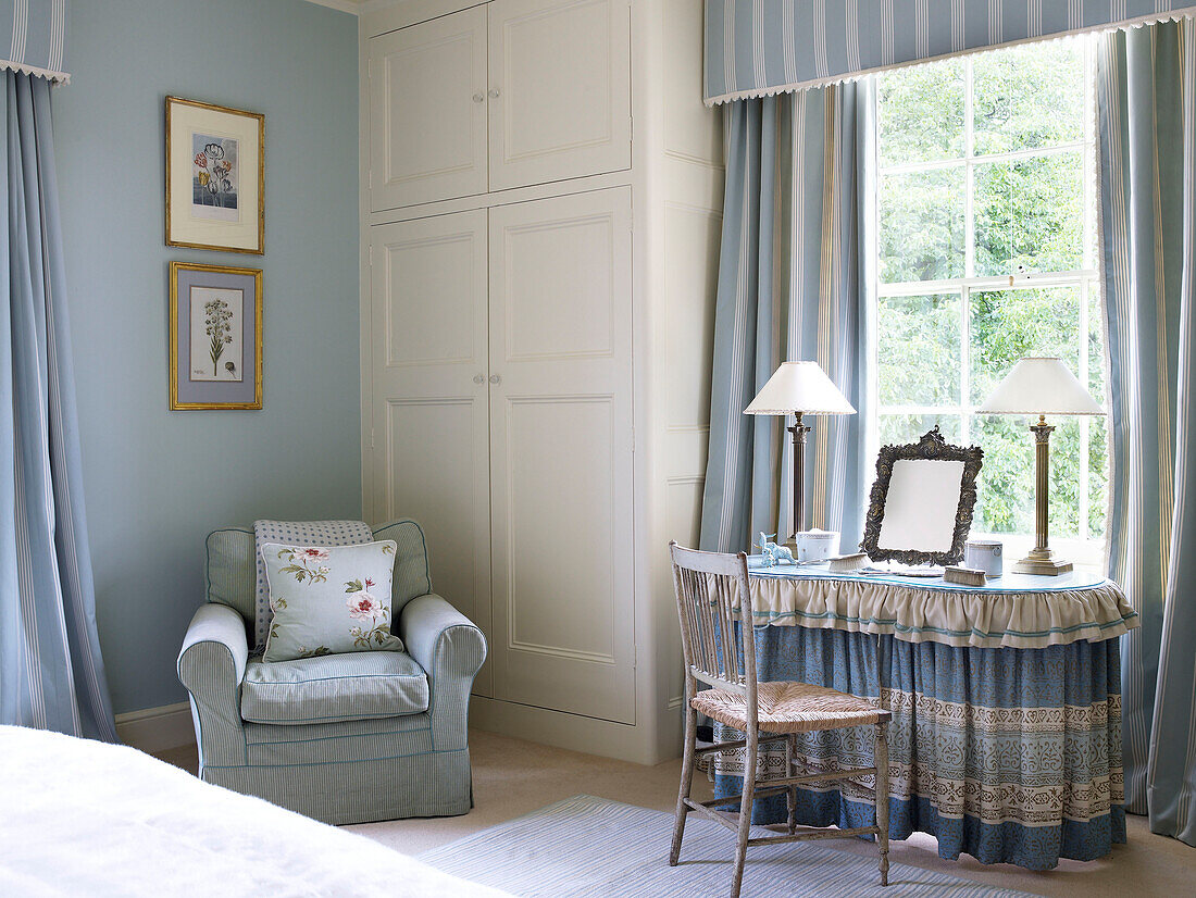 Dressing table at window in pastel blue bedroom of Lincolnshire country house, England, UK
