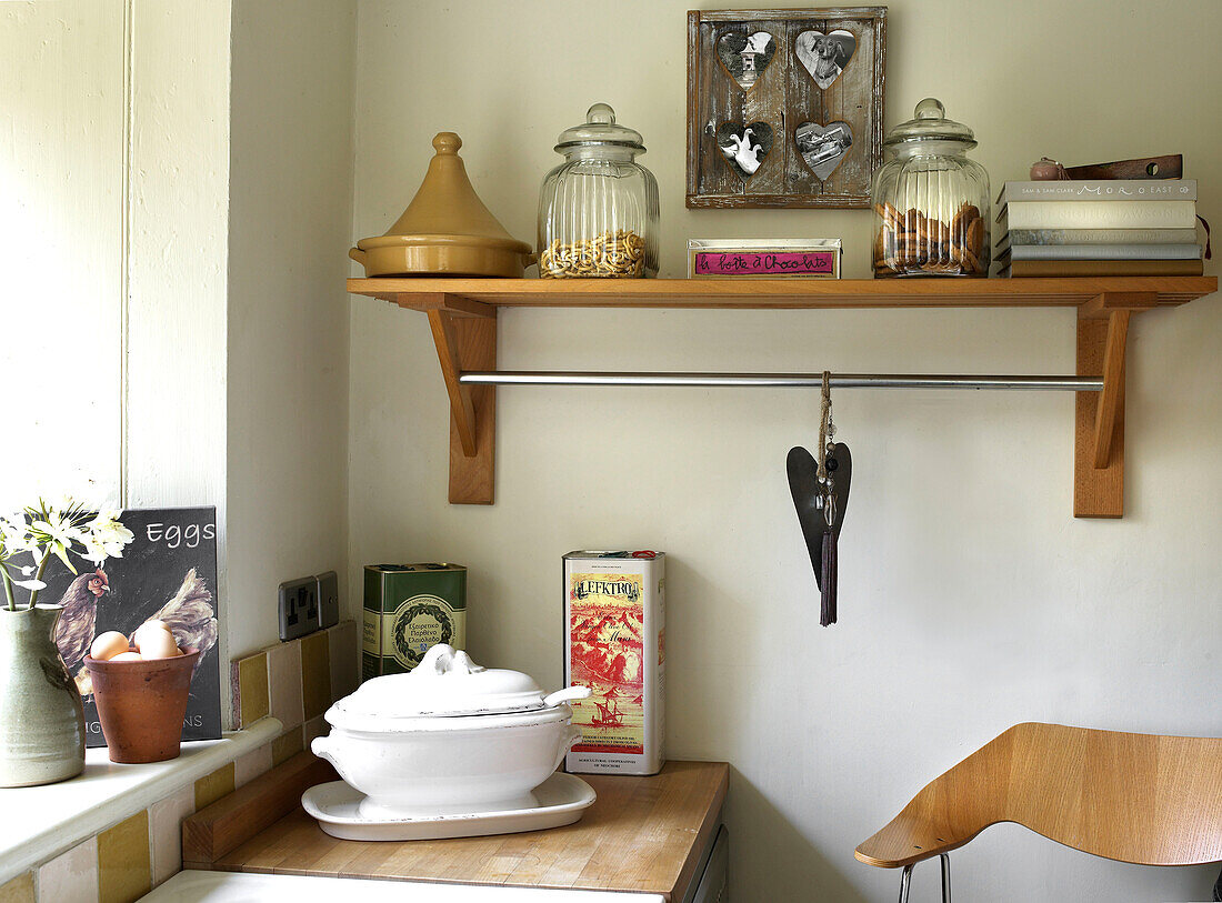 Kitchen shelf detail with homeware in Gloucestershire home with beamed ceiling England UK