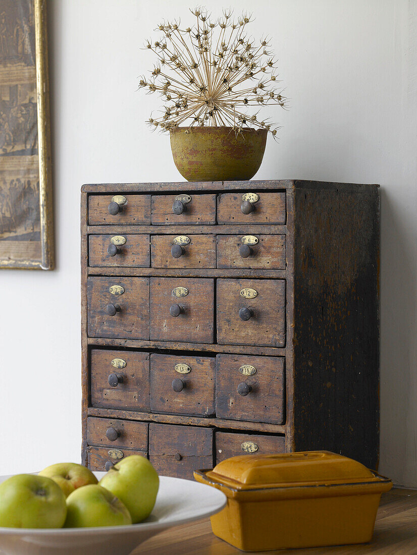 Antique storage cabinet with apples and butterdish in Gloucestershire home, England, UK