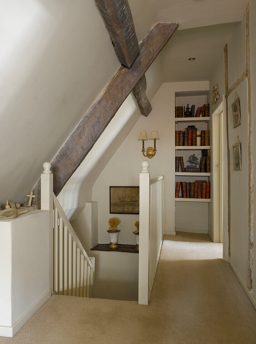 Recessed shelving on beamed landing of Gloucestershire home, England, UK