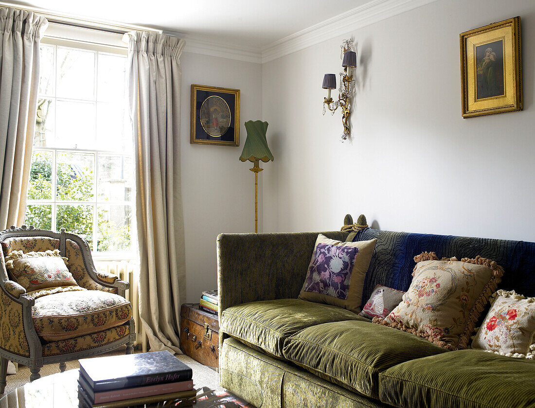 Green corduroy sofa with armchair at sunlit window city of Bath, Somerset, England, UK