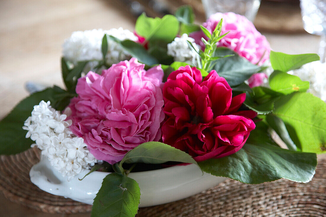 Pink and white centrepiece on dining room table in country house Suffolk, England, UK