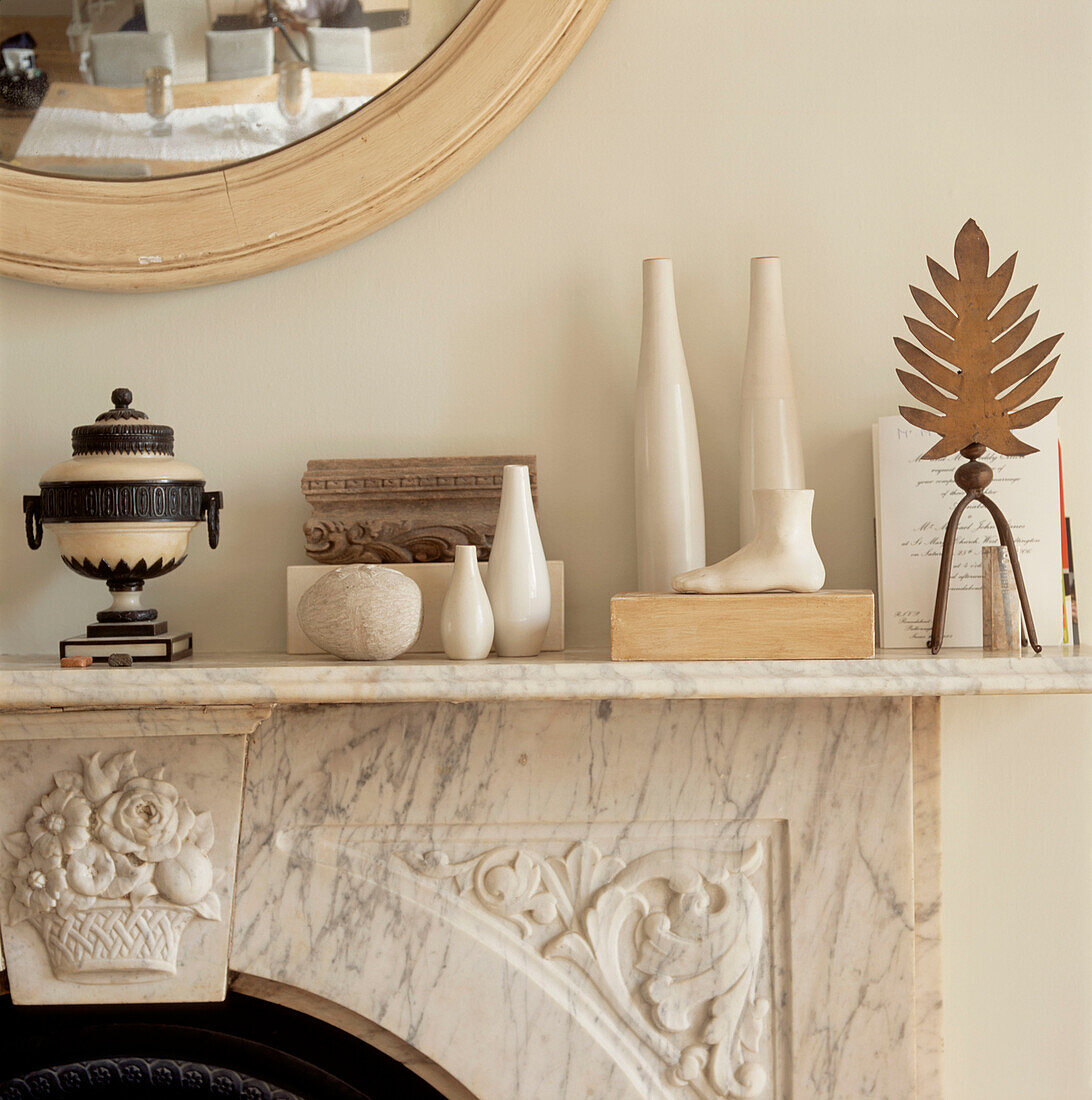 Detail of marble mantelpiece with home wares