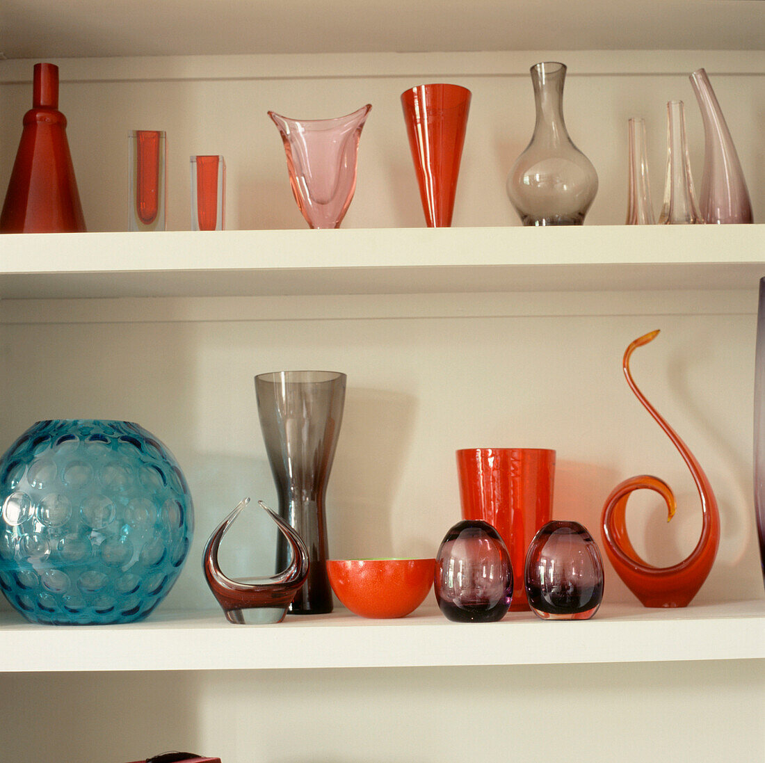 Open storage shelves displaying vintage glassware