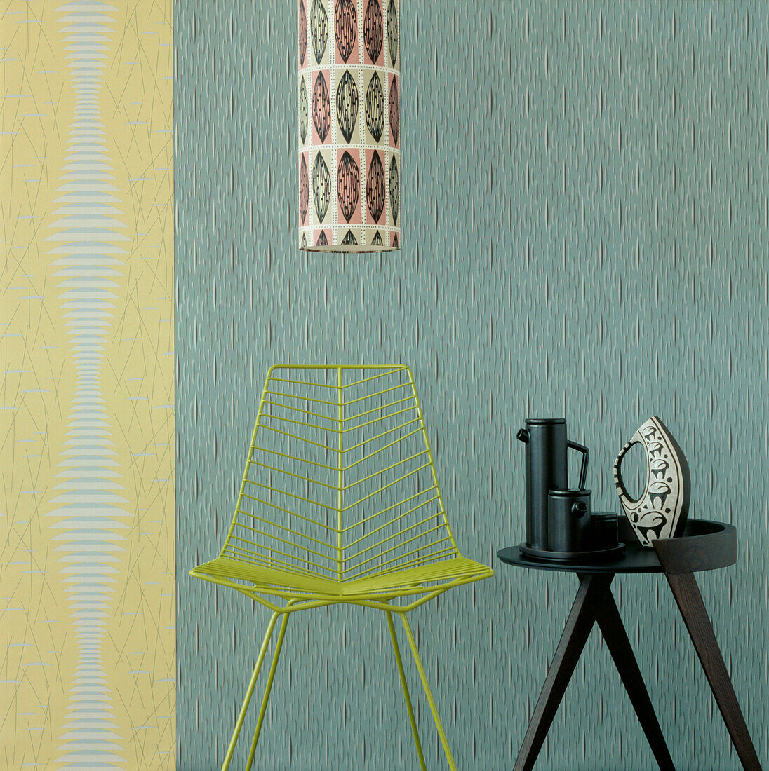 Yellow and green contemporary Art Deco style living room detail with textured wallpaper and modern home wares