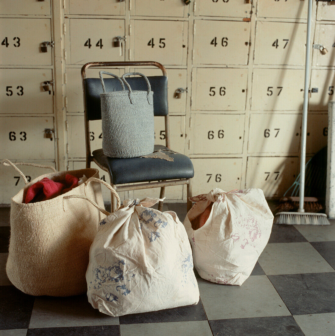 Bags of tied up laundry in a locker room