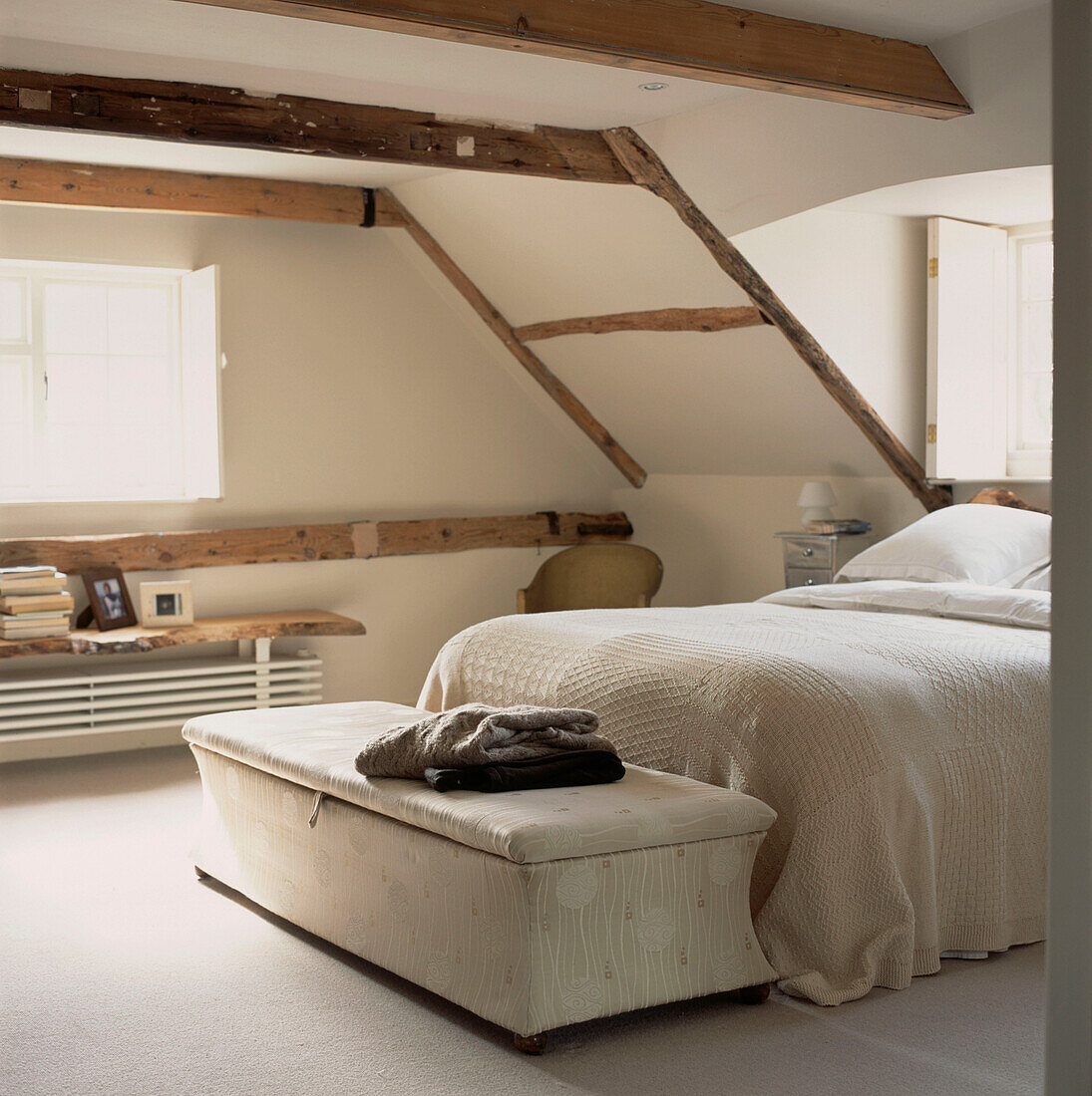 Small beamed attic bedroom with eaves and a double bed