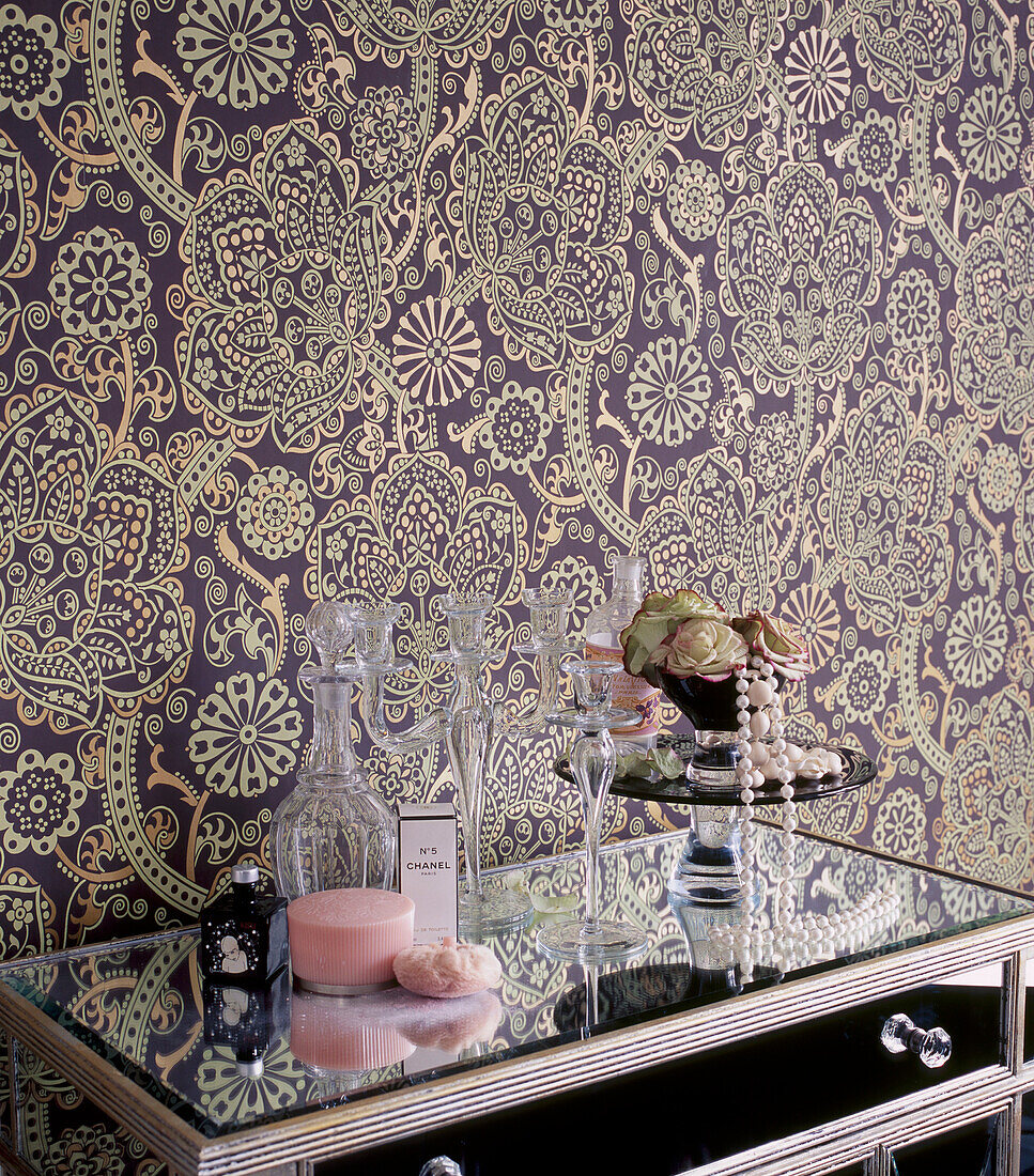 Bedroom with bold patterned wallpaper and mirrored dressing table