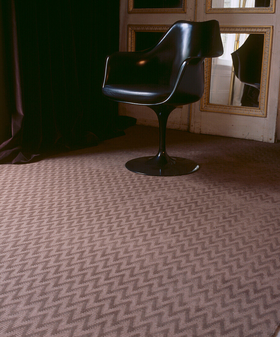 Patterned carpet with vintage retro chair
