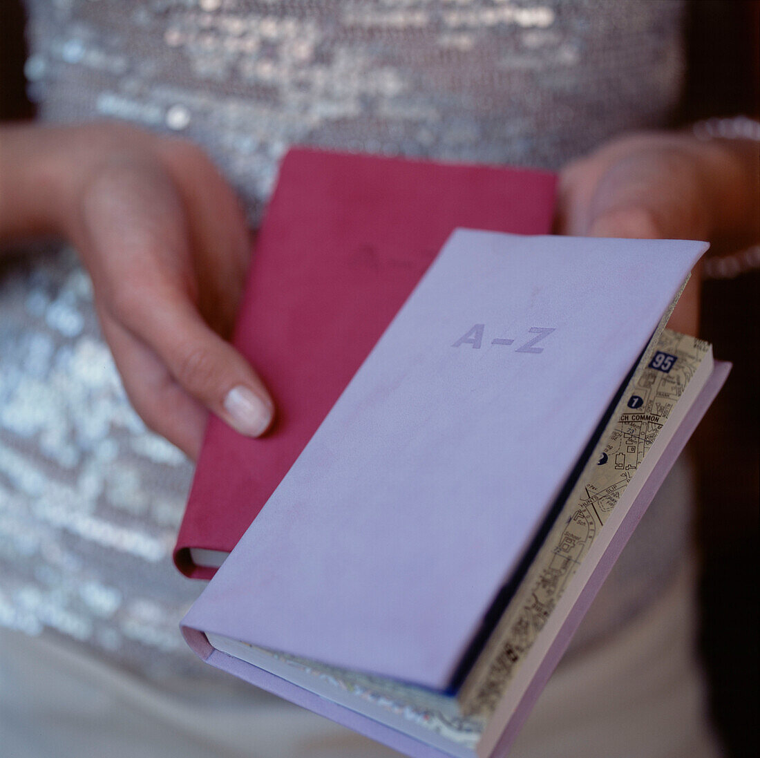 Frau mit einer A-Z-Karte und einem Journal in der Hand