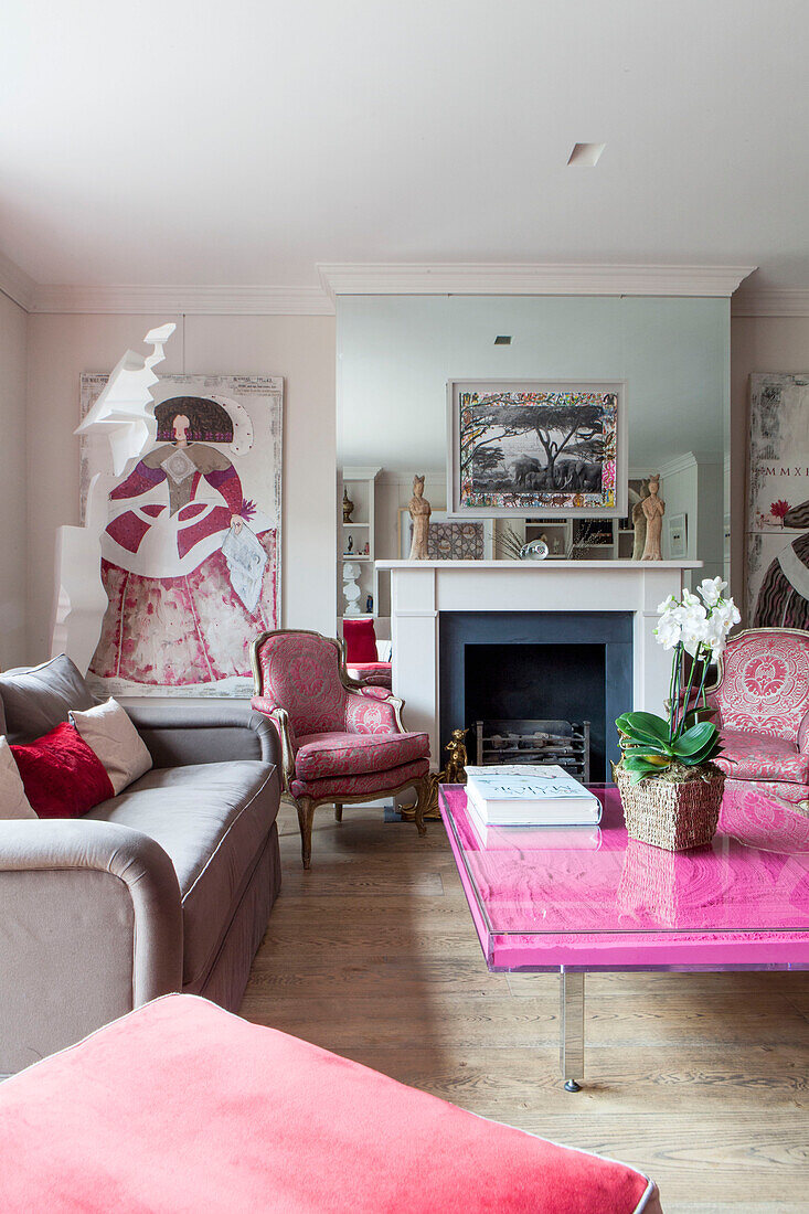 Orchid on pink coffee table in living room detail of contemporary London home England UK