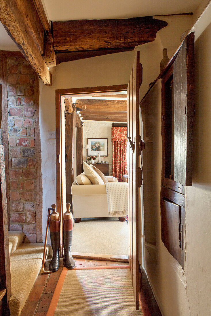 Riding boots at open doorway in Surrey farmhouse England UK