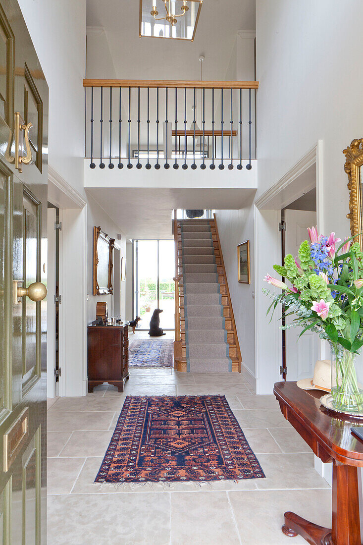 Double height hallway and entrance hall in Wiltshire country house England UK