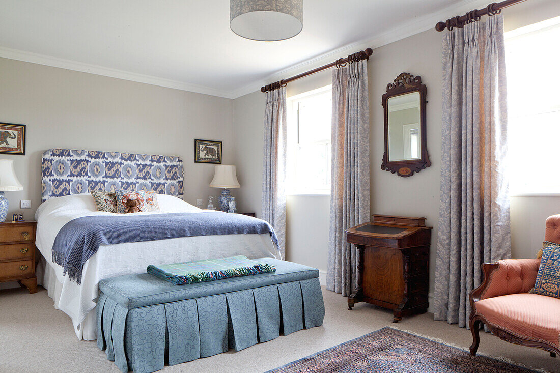 Blue furnishings in bedroom of Wiltshire country house England UK